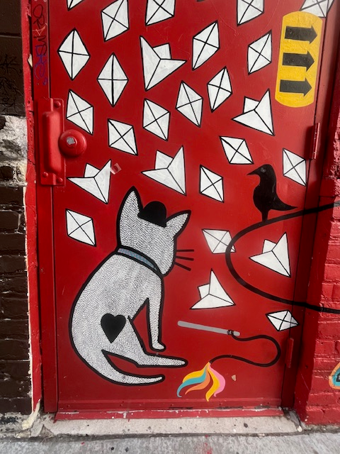 White cat and black bird